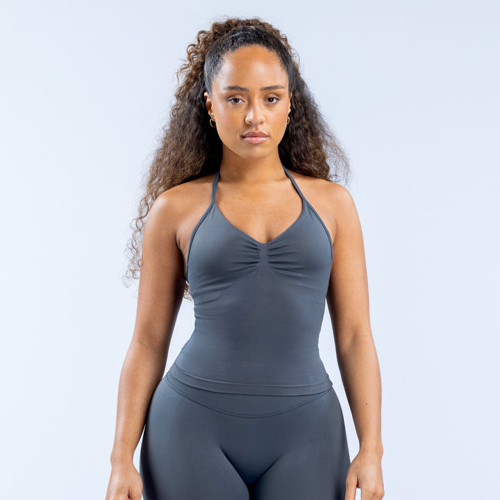 Dark gray longline strappy sports top with V neckline and ruched bust