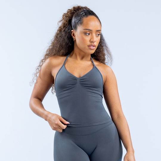 Dark gray longline strappy sports top with V-neck and ruched front