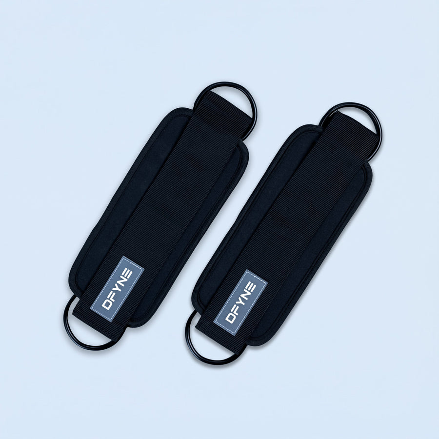 Black fabric ankle straps with curved buckle loops and printed logo patch