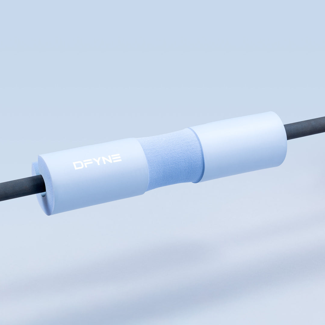 Barbell pad on barbell, light blue foam sleeve with DYNE logo.