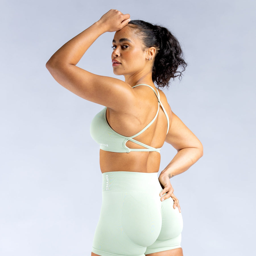 Mint green sports bra with open-back crisscross straps and racerback front