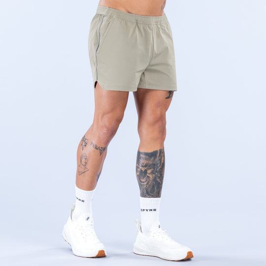 Olive 4-inch training shorts front view with elastic waistband and subtle logo