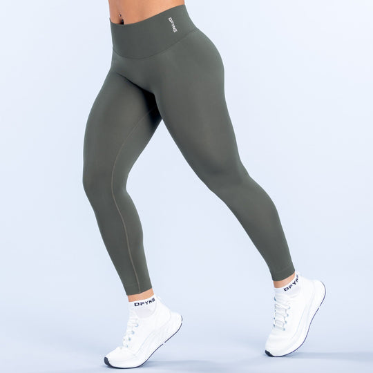 Olive green high-rise leggings with smooth flat seams and ankle-length fit