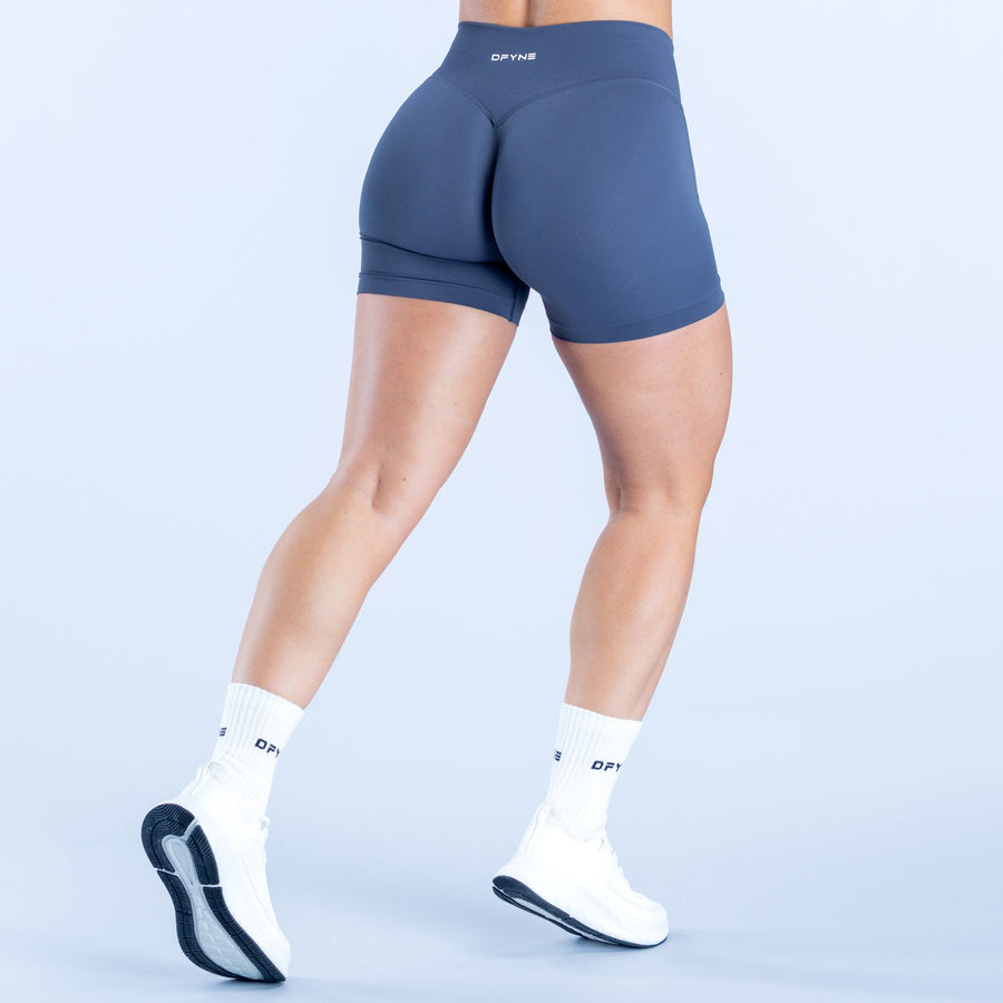 Navy 4.5-inch compression shorts, rear view with center seam and logo waistband