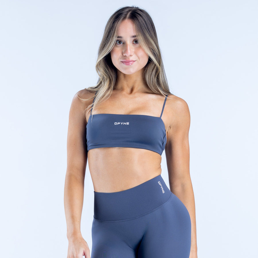 Navy strappy bralette with thin shoulder straps and front logo band