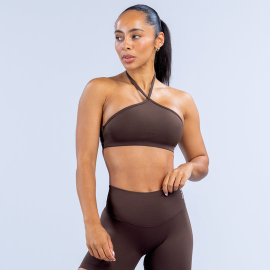 Dark brown high-neck halter sports bra with cross-back strap