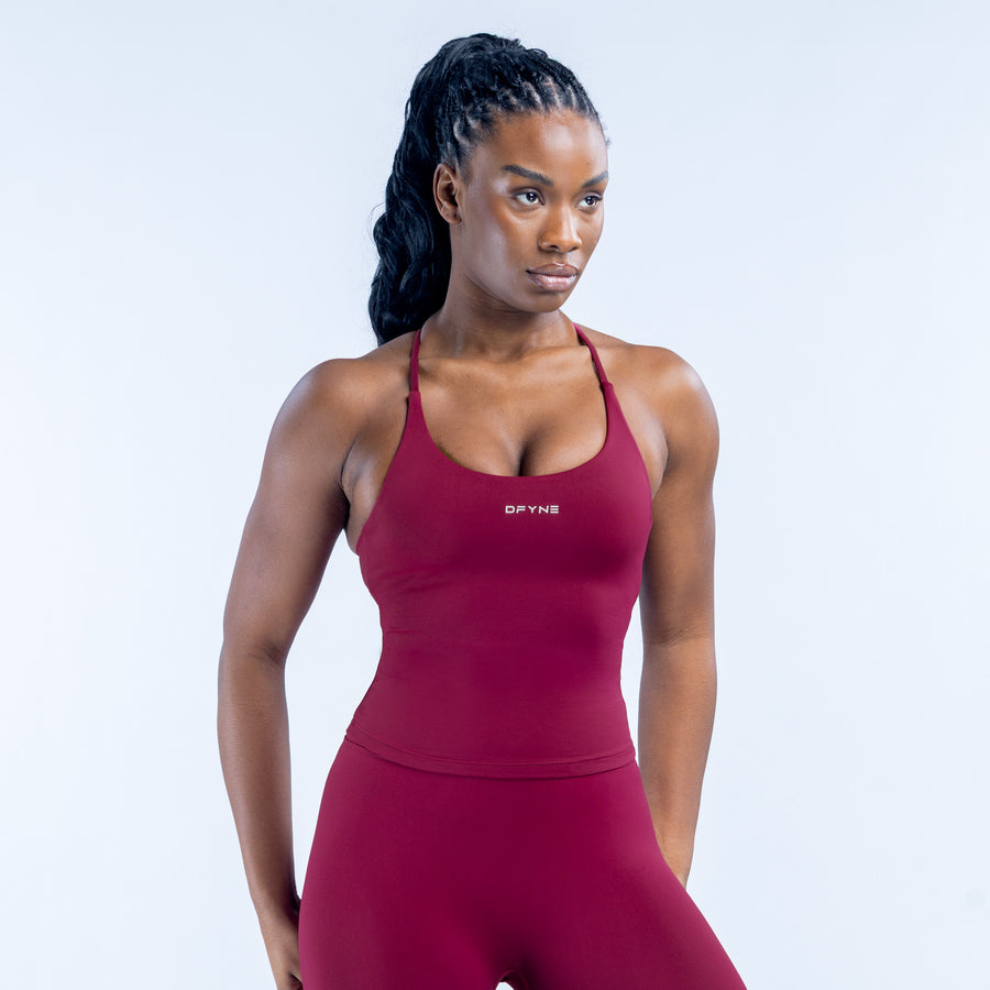 Burgundy sports tank top with thin straps and DYN logo