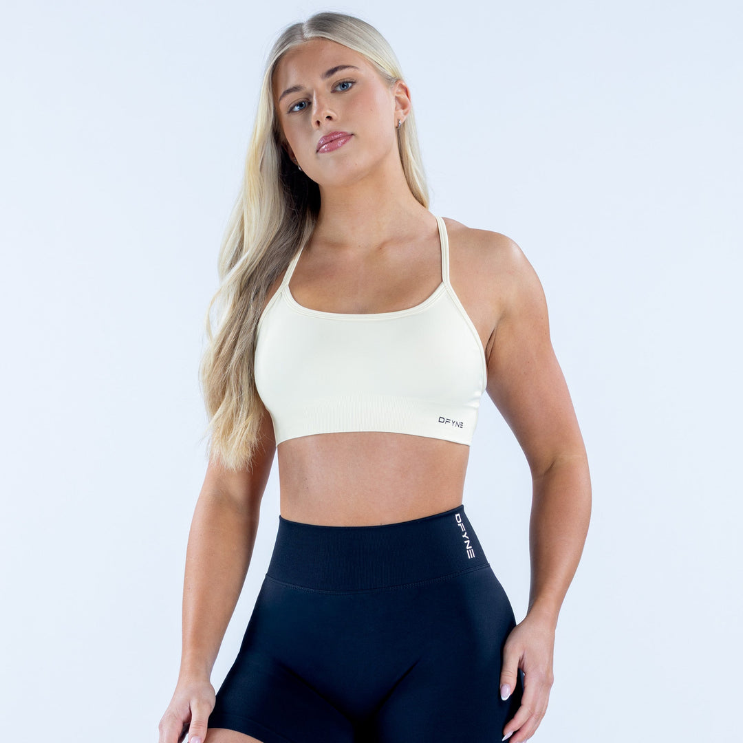 White backless sports bra with thin adjustable straps and scoop neckline