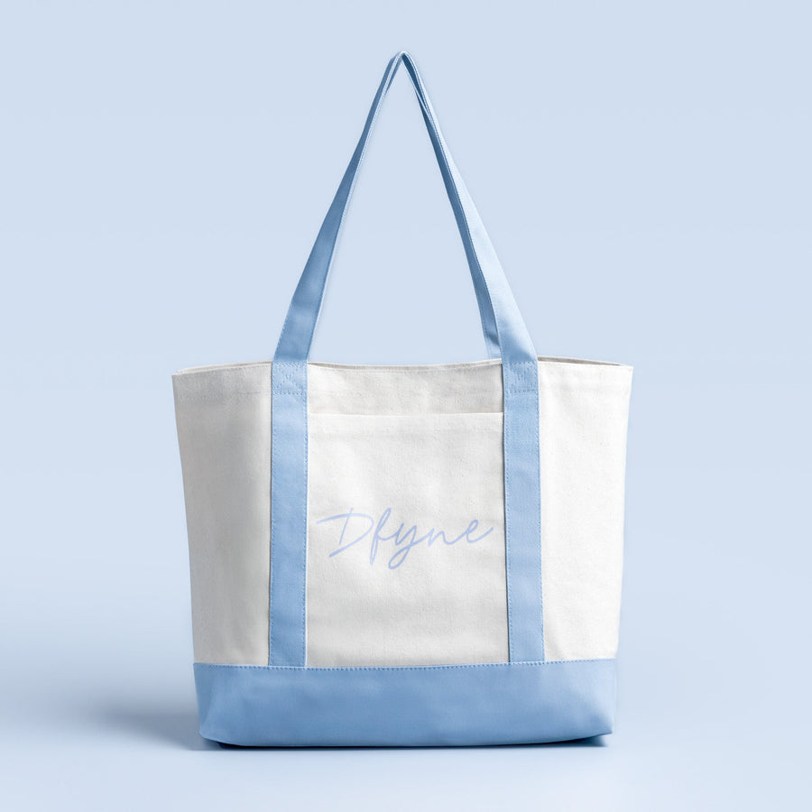 White tote bag with light blue trim and front script graphic