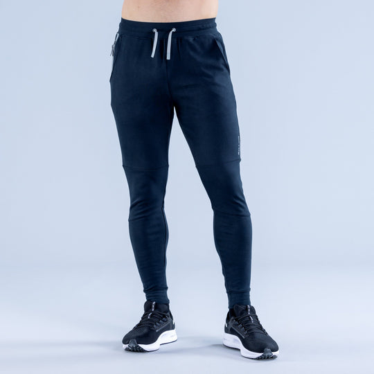 Dark navy tapered jogger pants, drawstring elastic waist, cuffed ankle