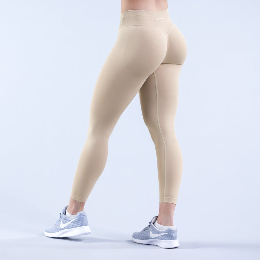 Light beige front-view leggings with tapered ankle length and branded waistband