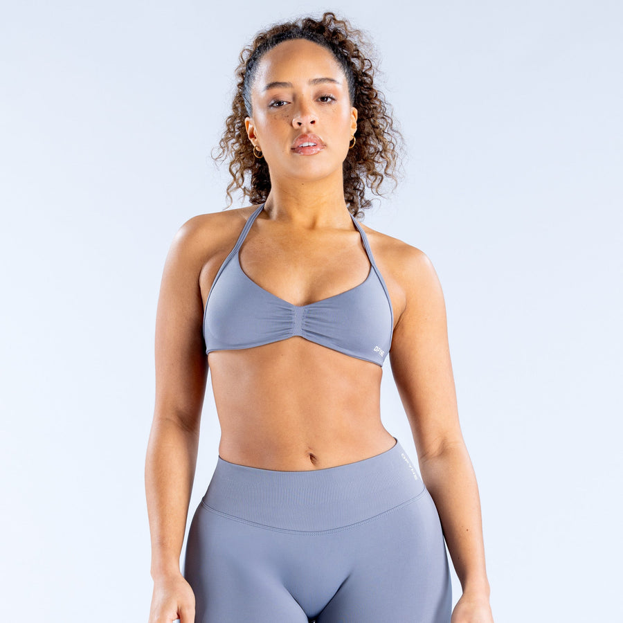 Women’s strappy sports bra, front view with ruched triangle cups and adjustable thin straps