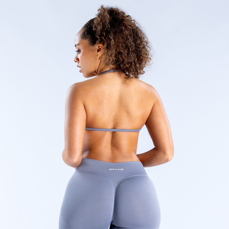 Women’s strappy sports bra, back view with thin racerback straps and small back label