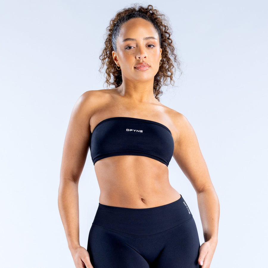 Black backless bandeau sports bra with wide elastic hem and logo on front