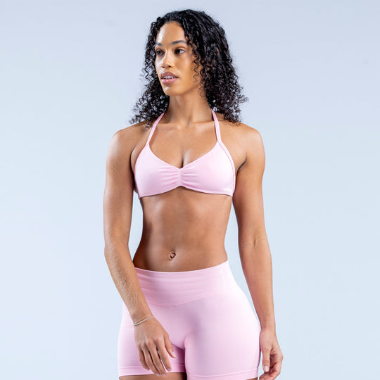 Light pink strappy bra with ruched center and thin shoulder straps