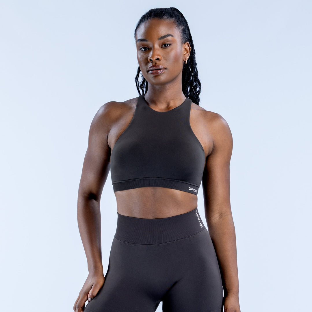 Black racerback sports bra with racer neckline and cropped front coverage
