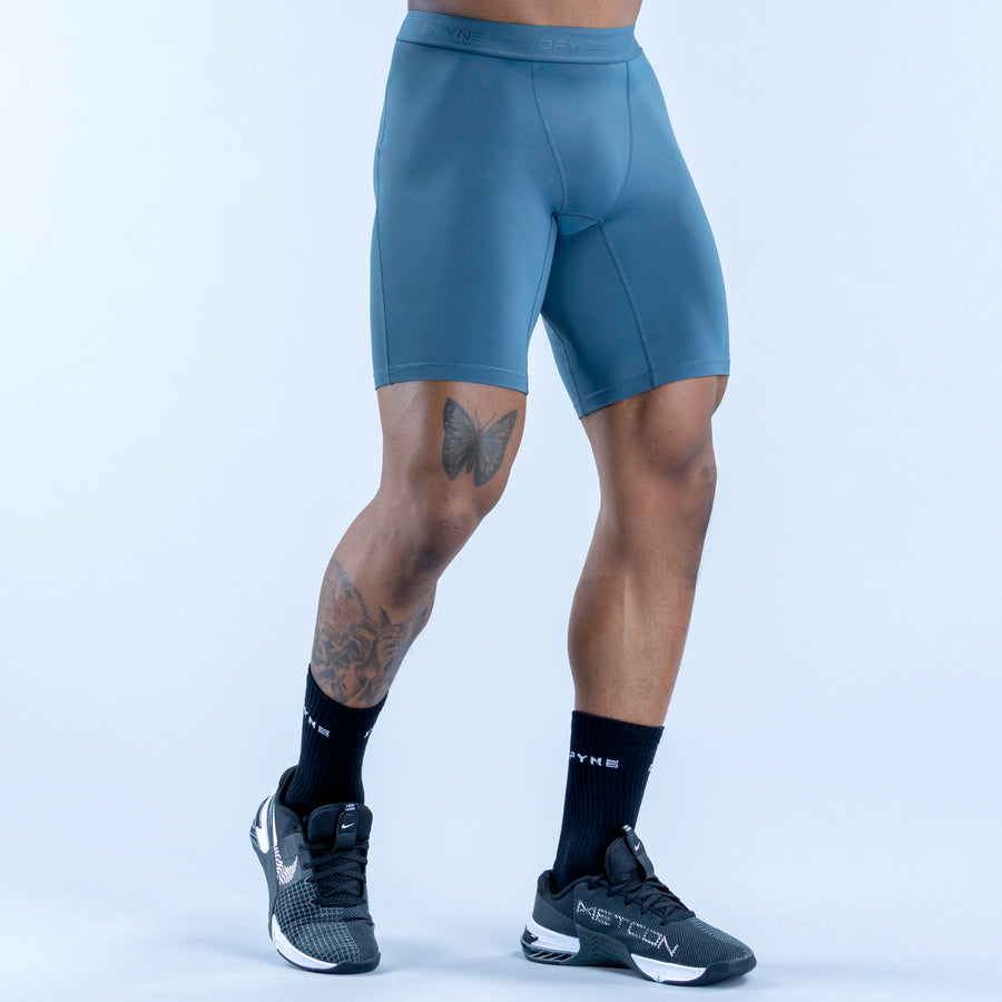 Unbound baselayer shorts in teal, front view with curved pocket seam