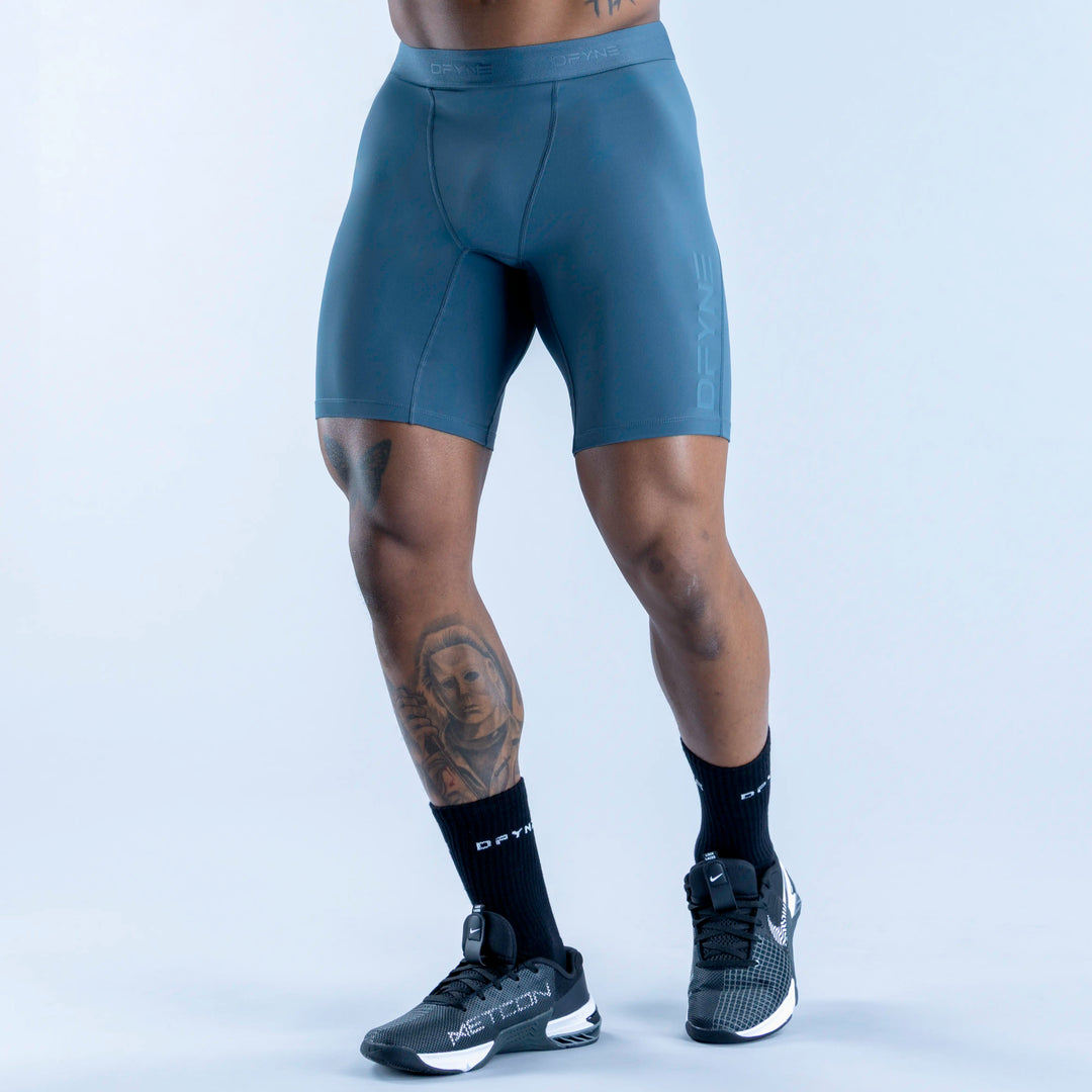 Unbound baselayer shorts in teal, form-fitting with waistband and leg seams