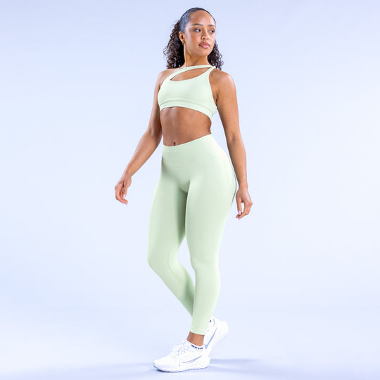 Light-mint asymmetric sports bra with front cutout and scoop neckline