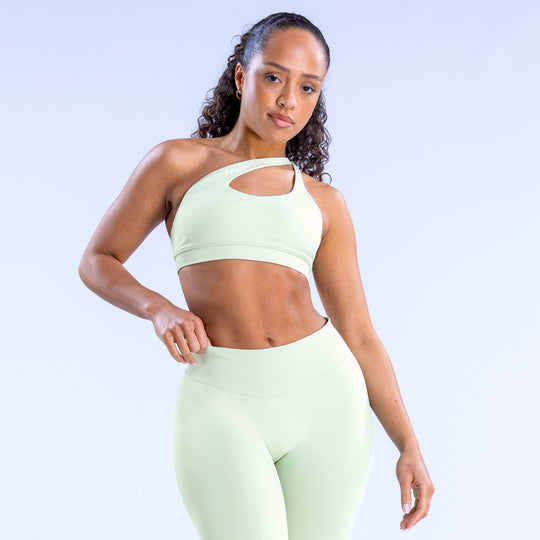 Asymmetric sports bra in light mint with front keyhole cutout and cropped fit