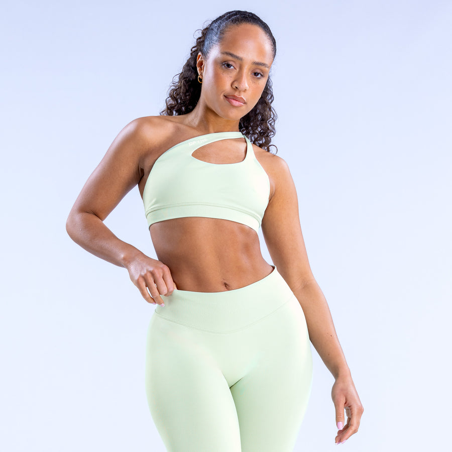 Asymmetric sports bra in light mint with front keyhole cutout and cropped fit