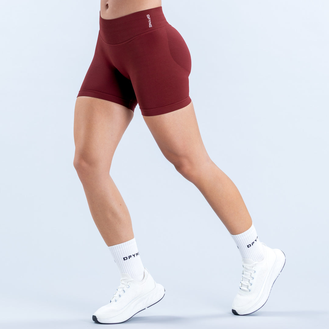 Burgundy 4.5-inch athletic shorts with a high waistband, shown from the side.