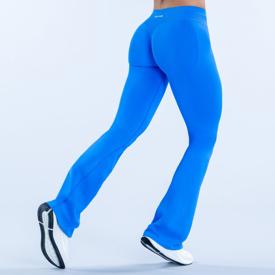 Blue flare athletic leggings, side view, flared leg opening