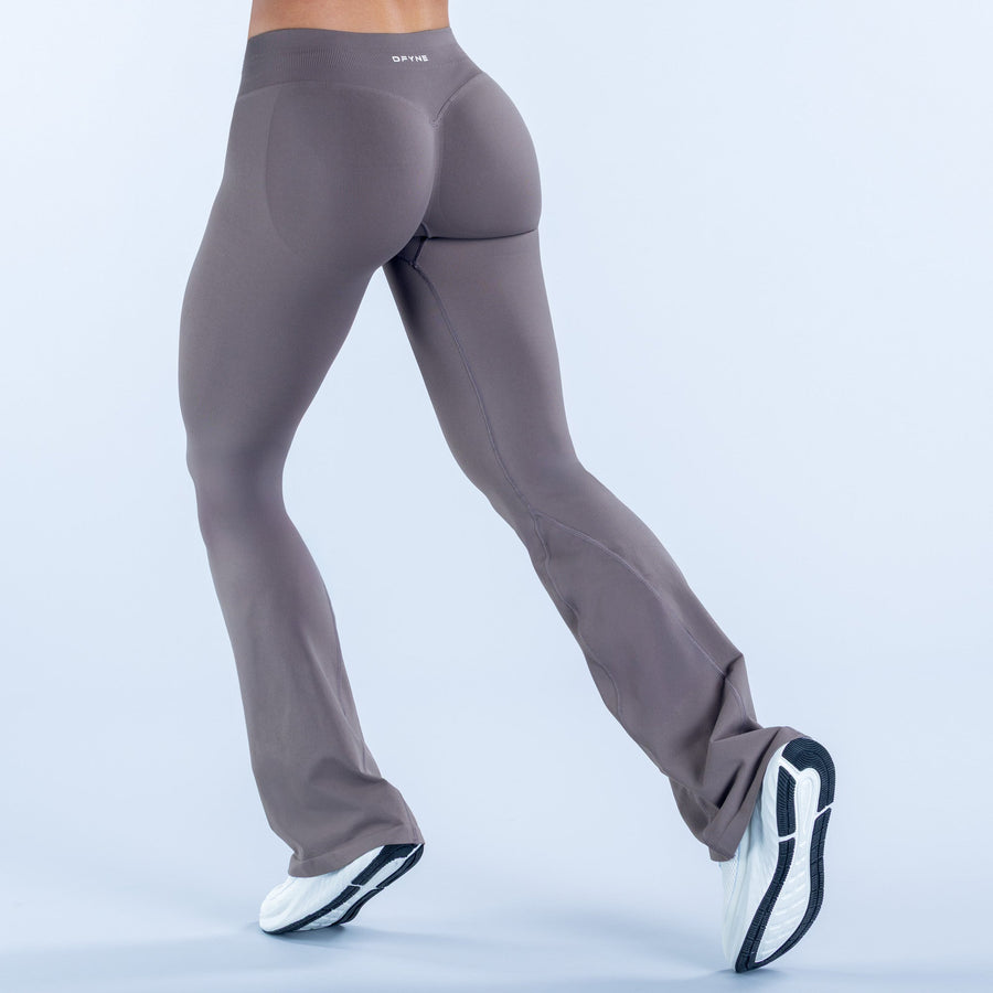 Dark gray high-waist flare leggings with smooth fabric and flared cuffs at the ankle