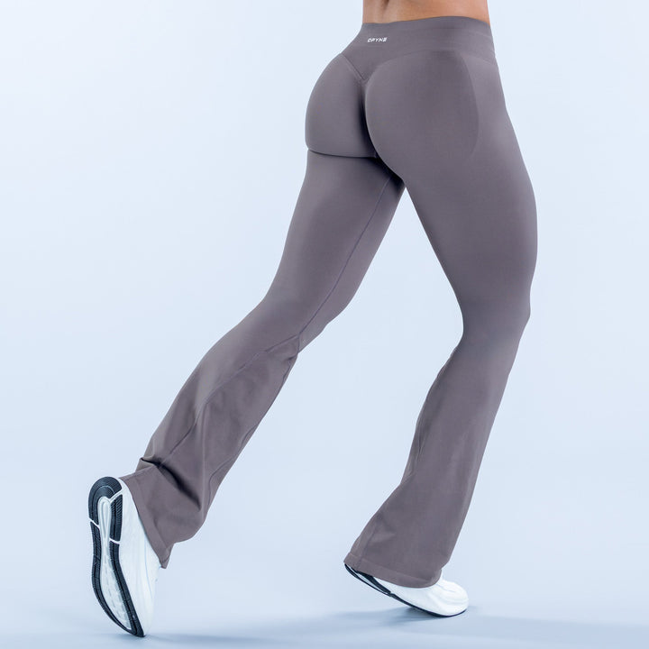 Dark gray flared leggings with high-rise waistband, curved back seam, bootcut legs