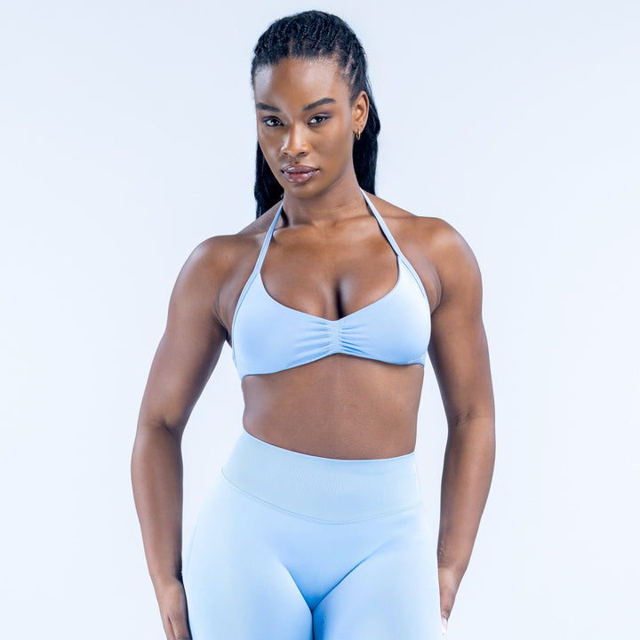 Light blue strappy impact bra with ruched center front and halter-style straps