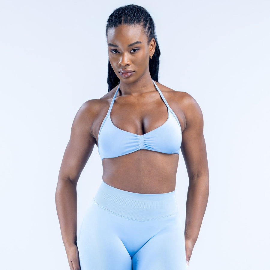 Light blue strappy impact bra with ruched center front and halter-style straps