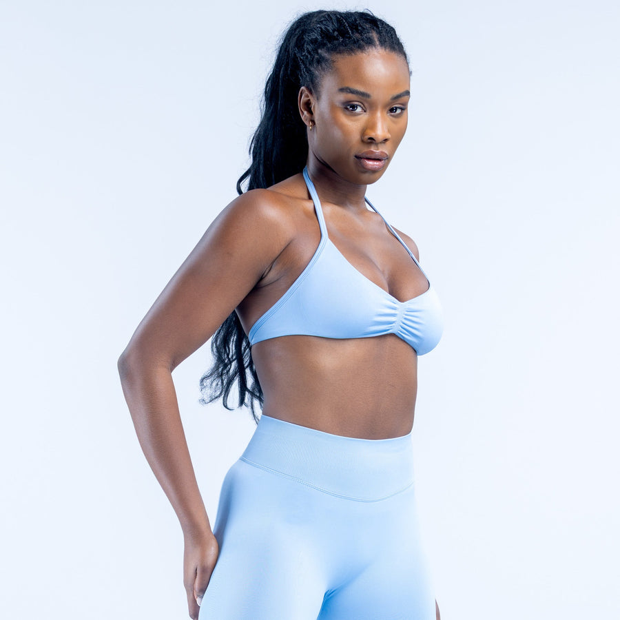 Light blue strappy impact bra with gathered center and adjustable thin shoulder straps
