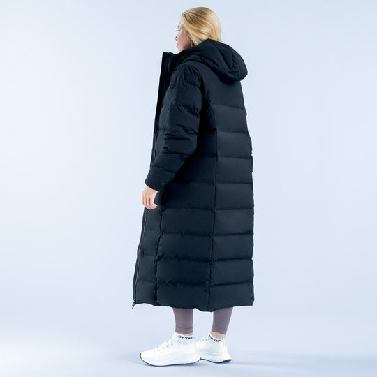 Women's black long down jacket, side back view with quilted panels and hood