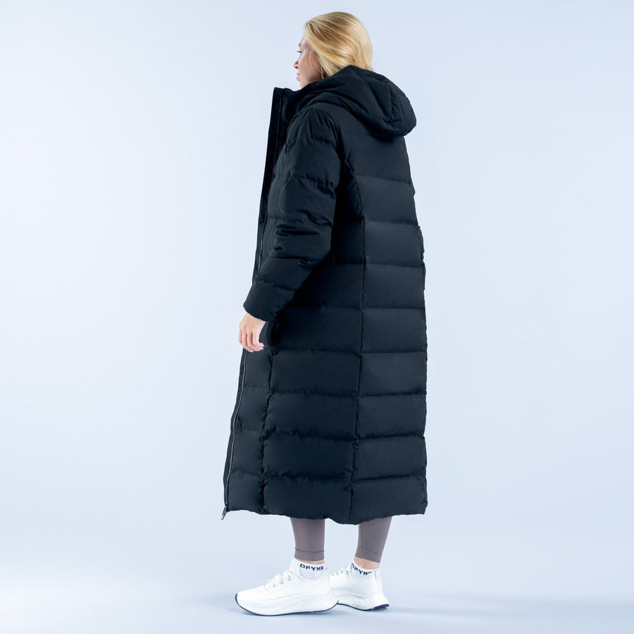 Women's black long down jacket, side back view with quilted panels and hood