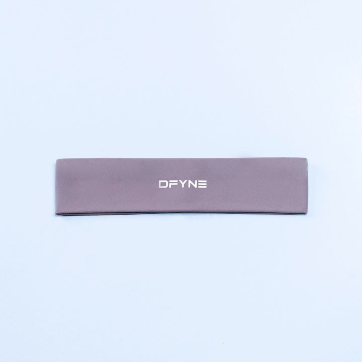 Mauve Origin headband with DFYNE logo, flat lay.
