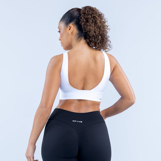 Origin sports bra white back with scooped neckline and racerback straps