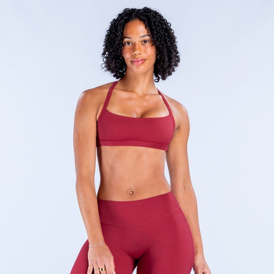 Rugby red sports bra with wide crisscross straps and smooth scoop neckline