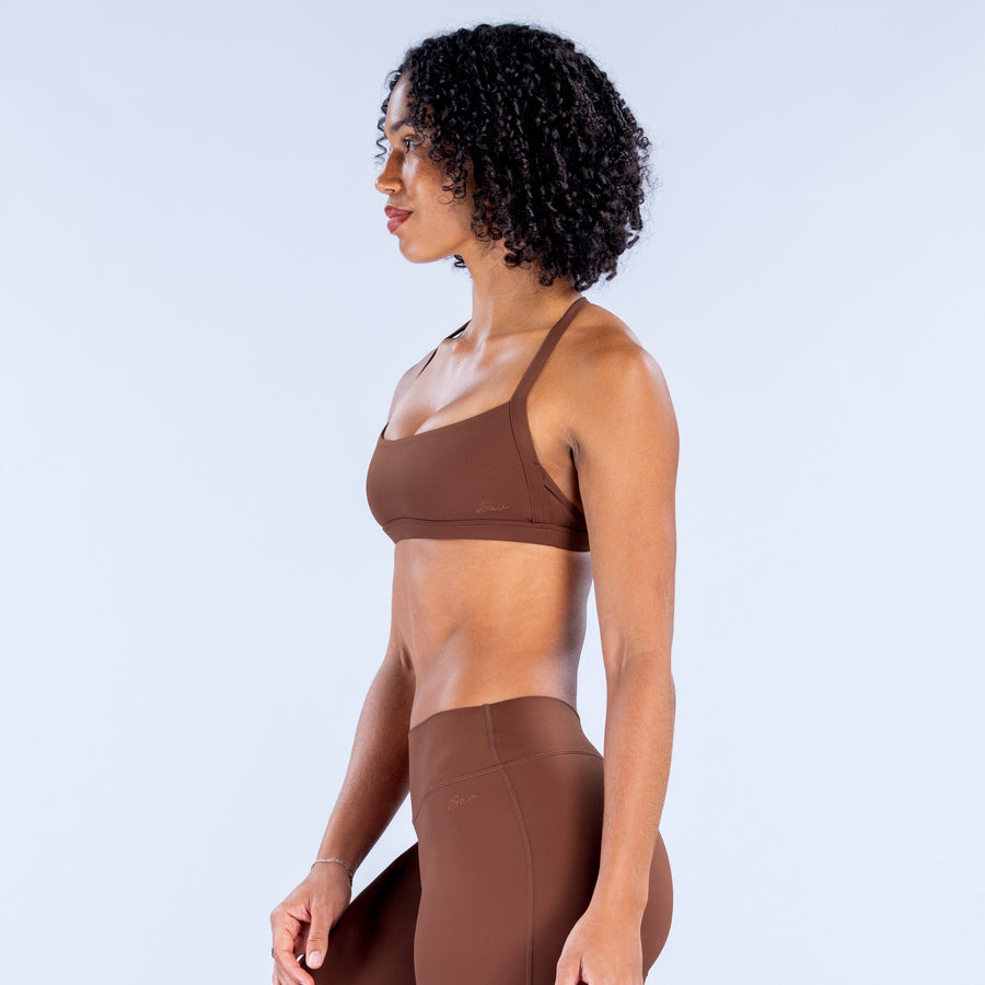 Dark brown sports bra with slim straps and racerback, side view