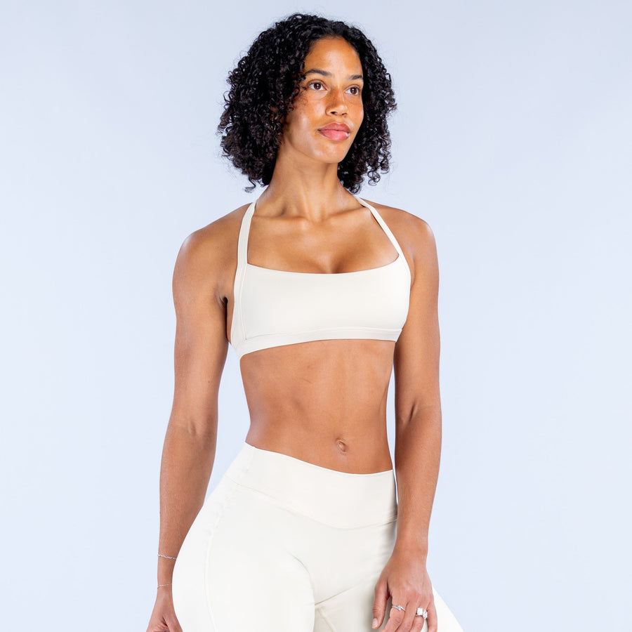 White sports bra with square neckline and supportive fit