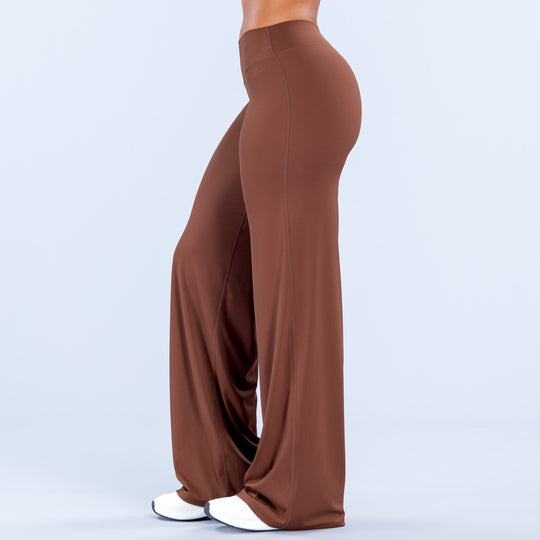 Brown wide-leg pants, side view, smooth fabric with draped wide flare