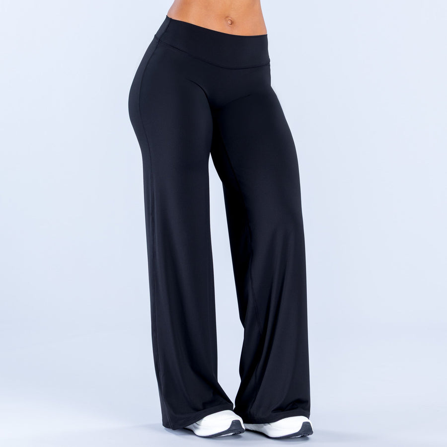 Wide-leg pants in dark black, front view with smooth drape and flared wide hems.