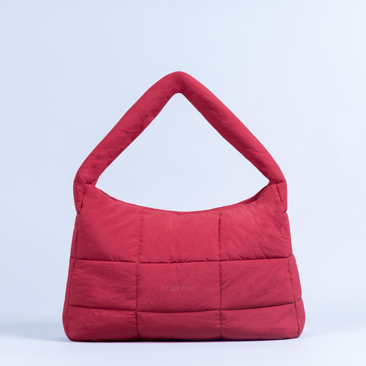 Red puffer tote bag with top handle, quilted panels, and center logo.