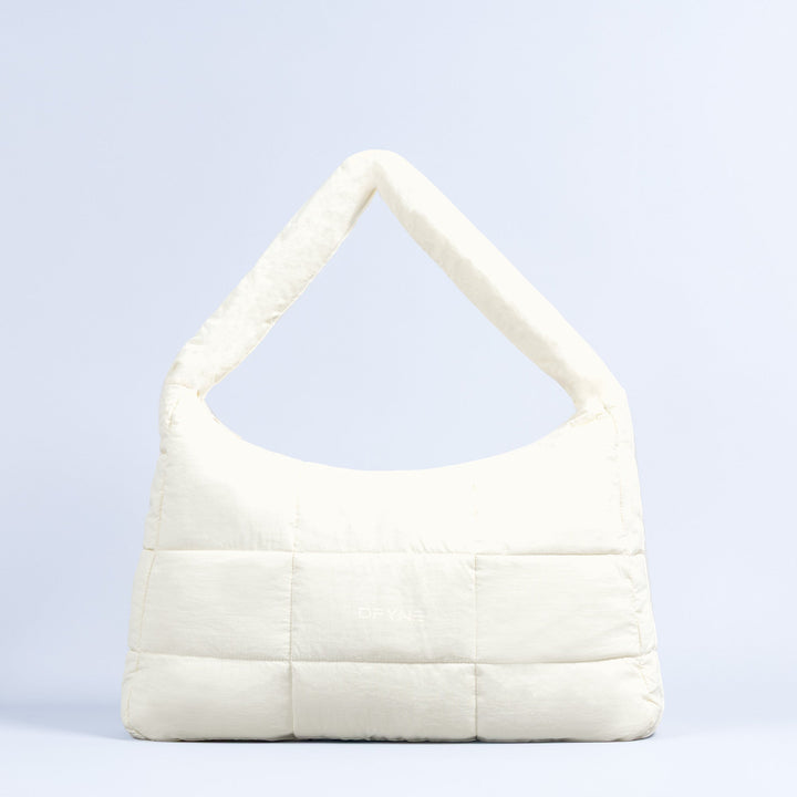 Sav puffer bag in ivory with wide base, quilted front, and top handle