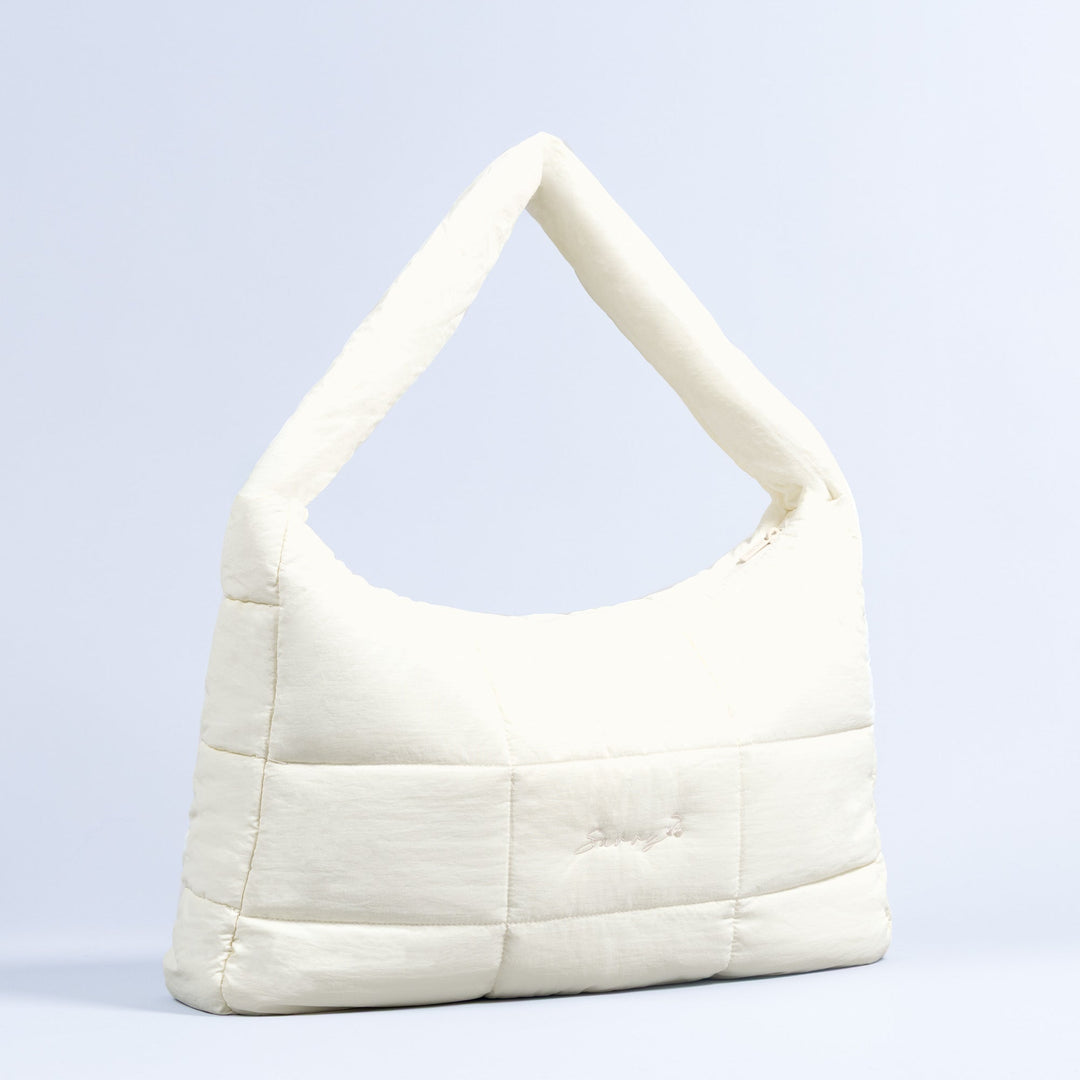 Sav puffer bag in ivory with top handle and quilted panels
