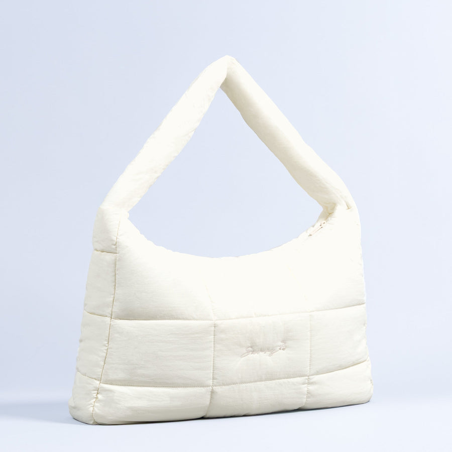 Sav puffer bag in ivory with top handle and quilted panels