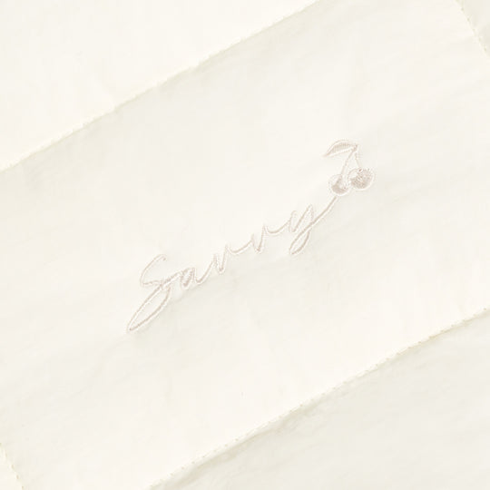 Sav puffer bag with embroidered 'Sav' script logo on ivory fabric