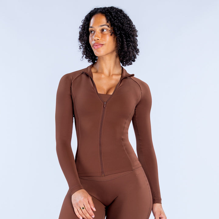 Brown zip-front athletic bodysuit with long sleeves and high neckline