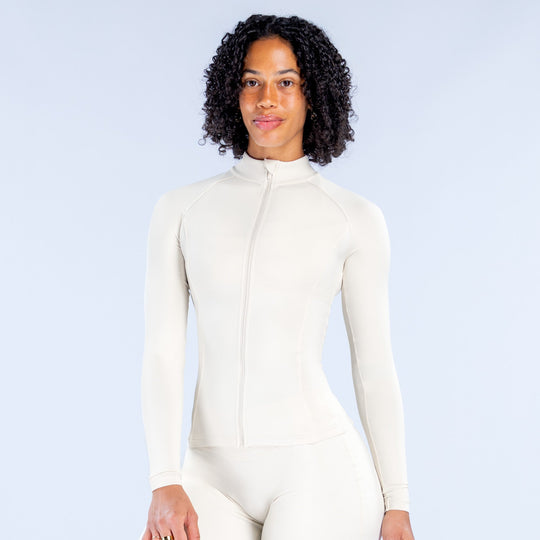 Off-white Sav Zippy full-zip long-sleeve top with stand collar, paired with leggings