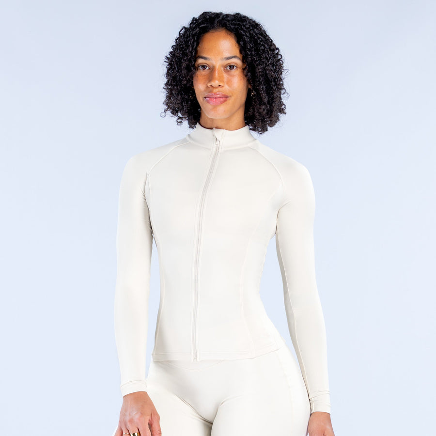 Off-white Sav Zippy full-zip long-sleeve top with stand collar, paired with leggings