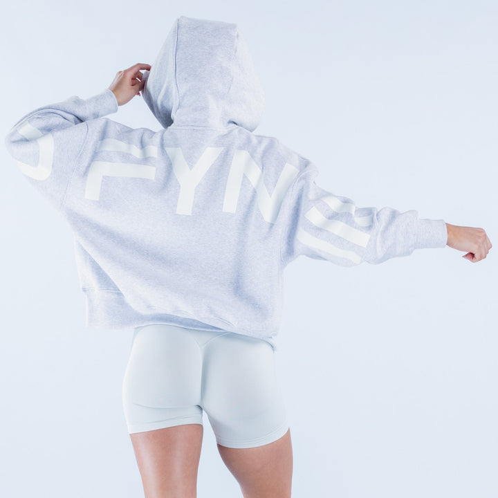 Light blue hoodie with large white back logo text and hood